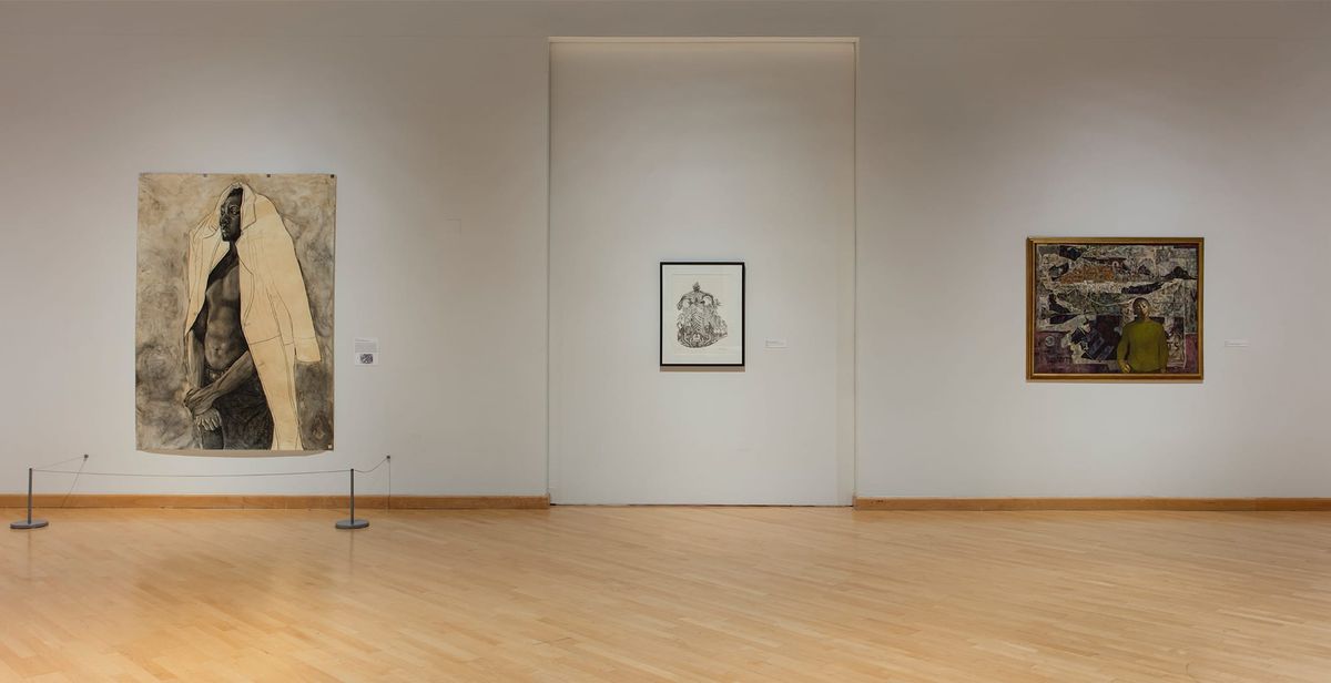 Installation view with focus on painting of man wearing overcoat on his head