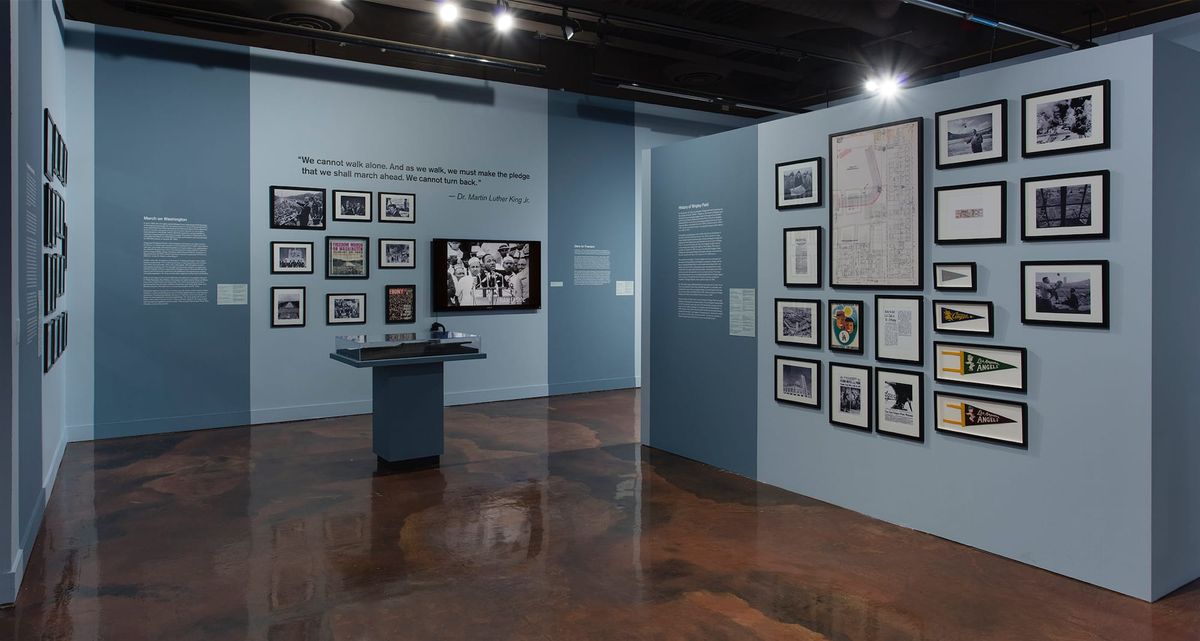 Installation view of monitor, photo elements, and vitrines