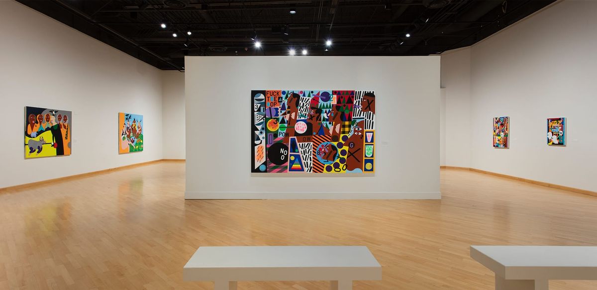 Installation view of very large scale painting of black heads in profile