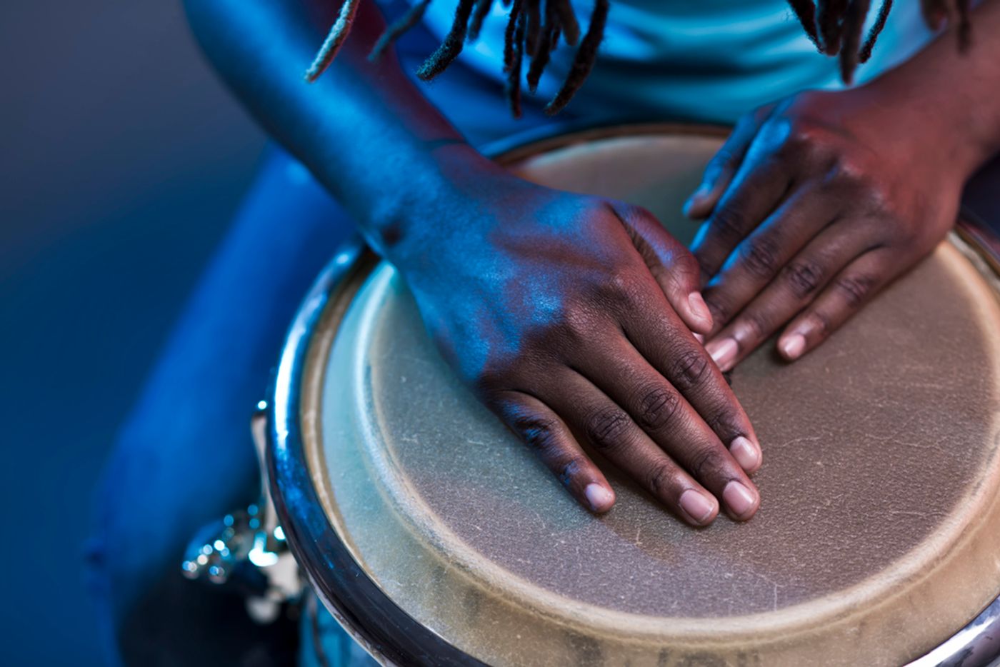 Hands resting on the top of a drum