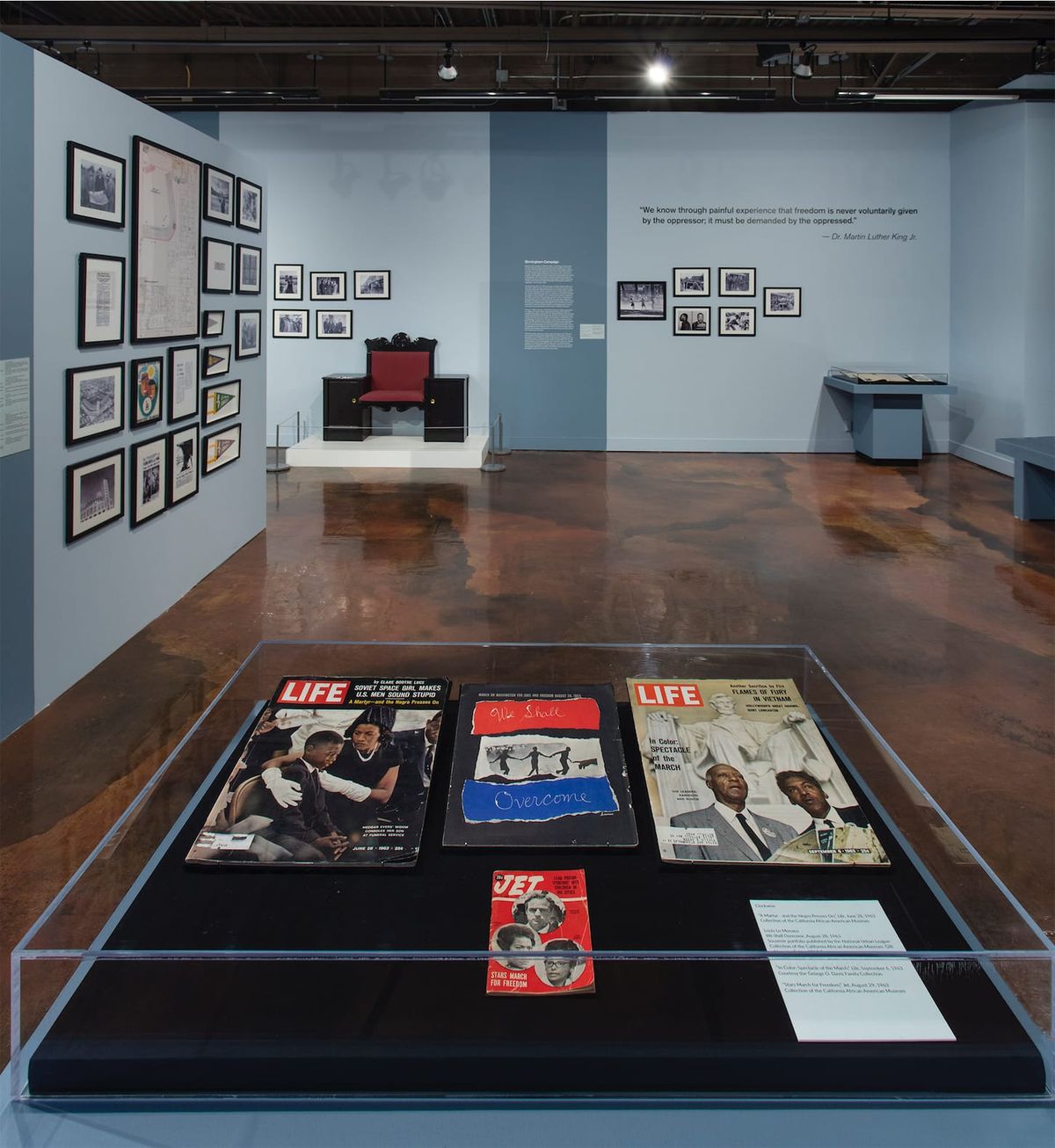 Installation view of monitor, photo elements, and vitrine