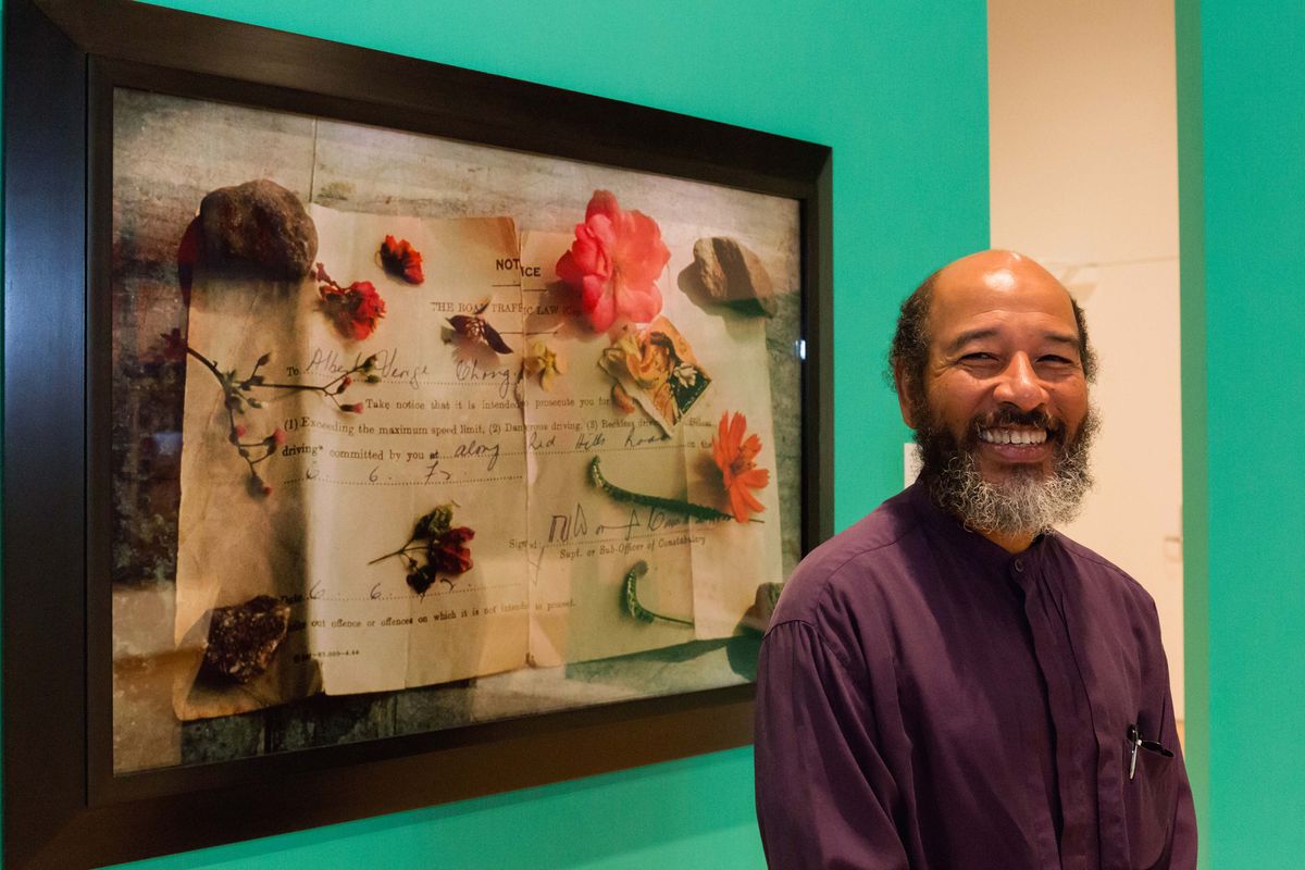 Portrait of Albert Chong in front of his work