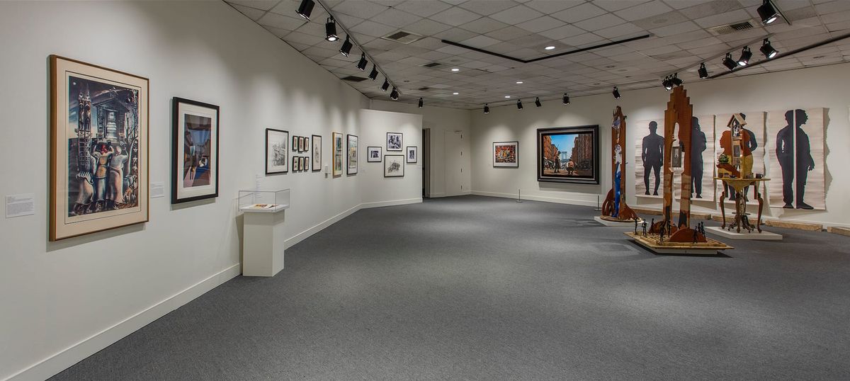 Installation view of framed works and sculpture