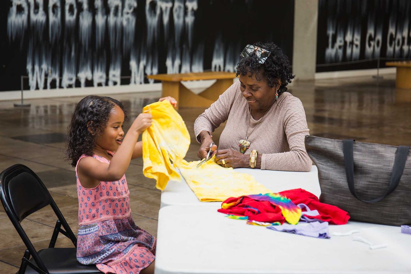 Family participating in  textile art workshop