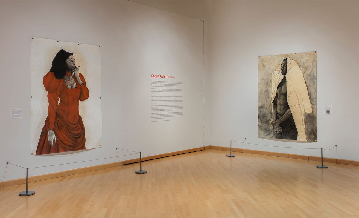 Installation view of large scale paintings of woman in red dress and man wearing overcoat on his head