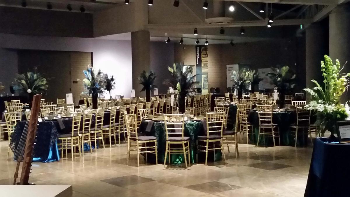 Atrium set up with elegant floral arrangements, dining tables, and mood lighting