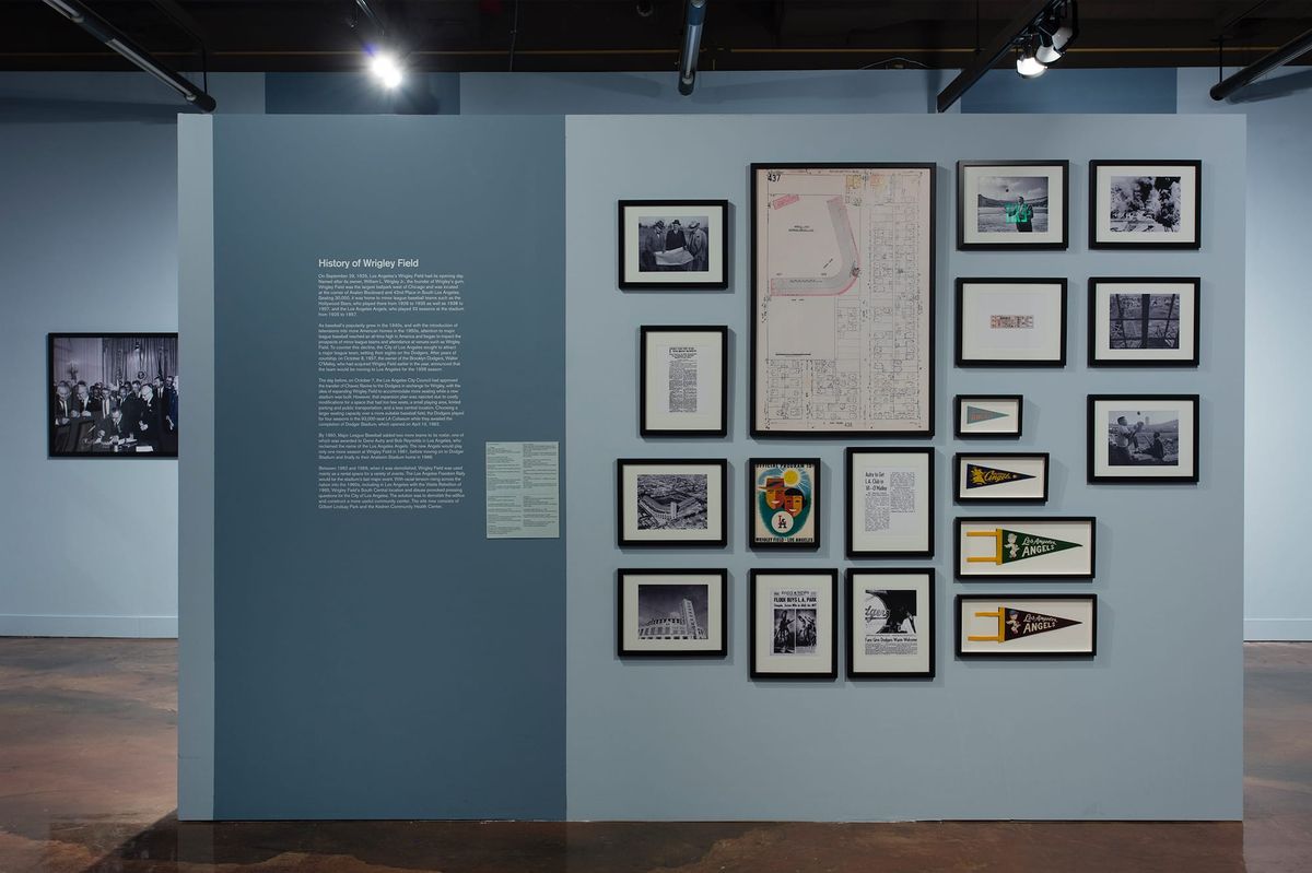 Installation view of wall text, monitor, and photographs