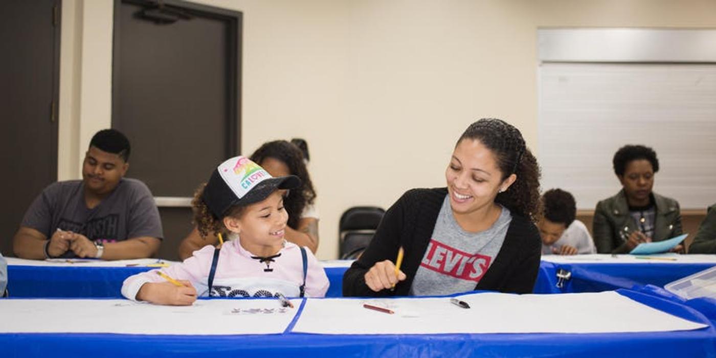 Family participating in an art workshop
