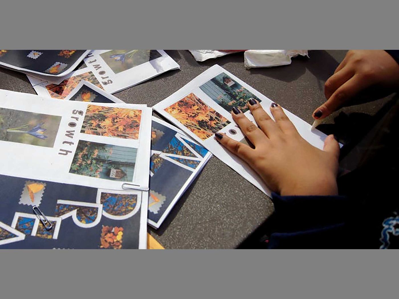 Manicured hands burnishing papers during workshop