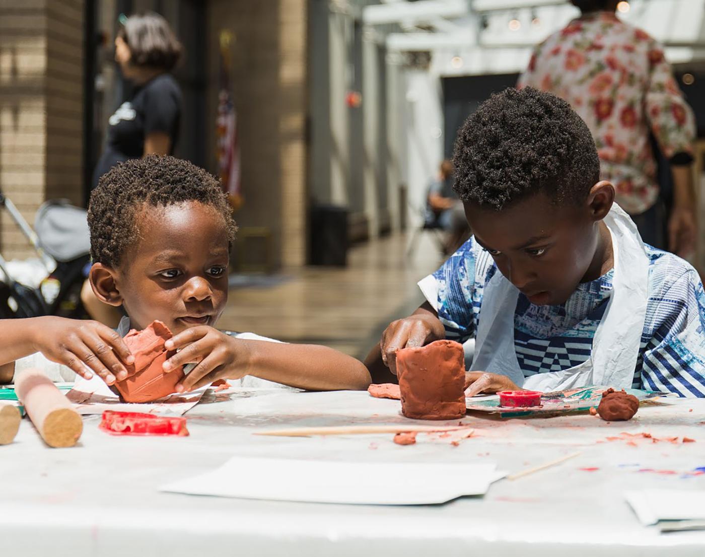 Small children working together using art materials