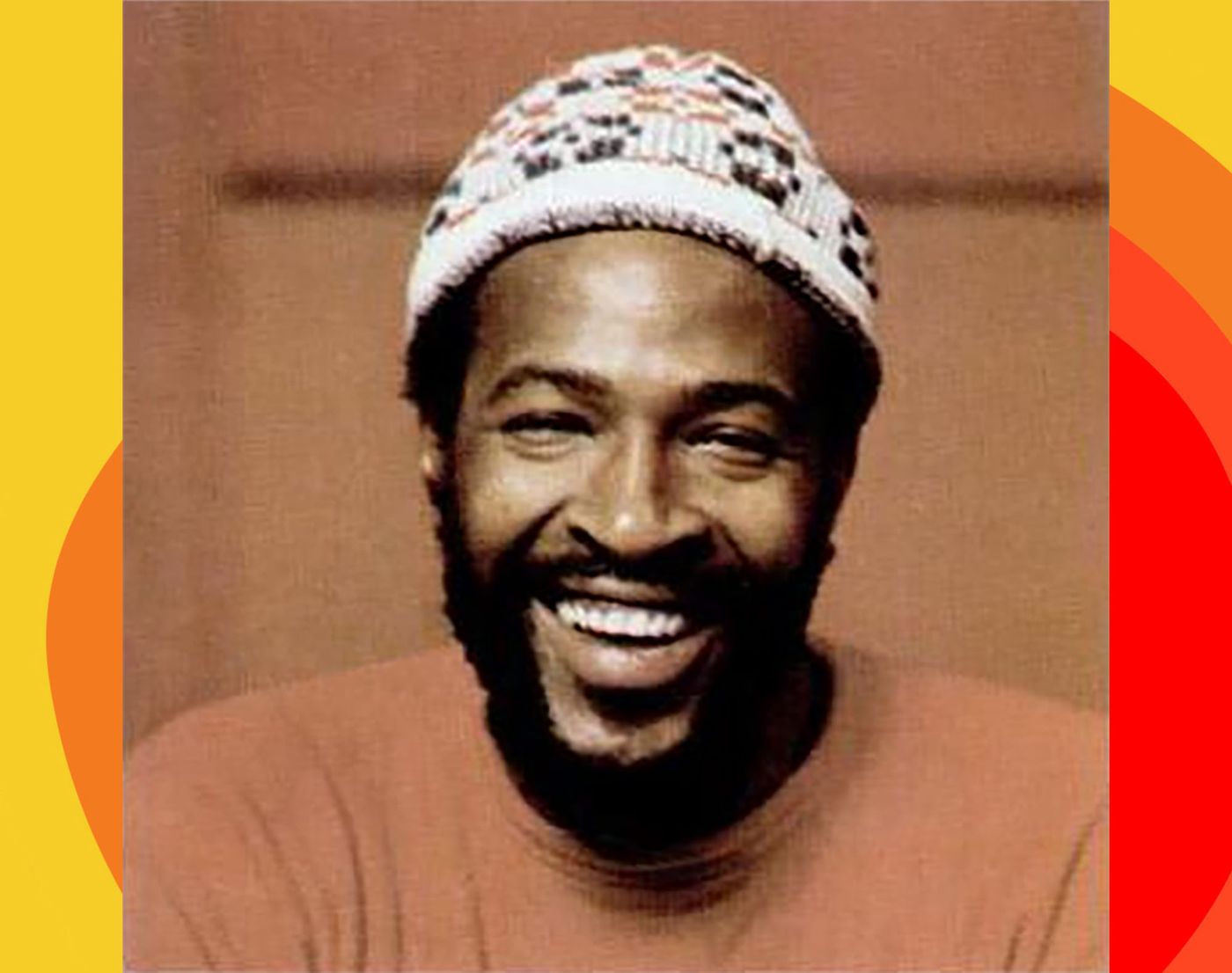Close portrait of Marvin Gaye with beard, wearing knitted cap.