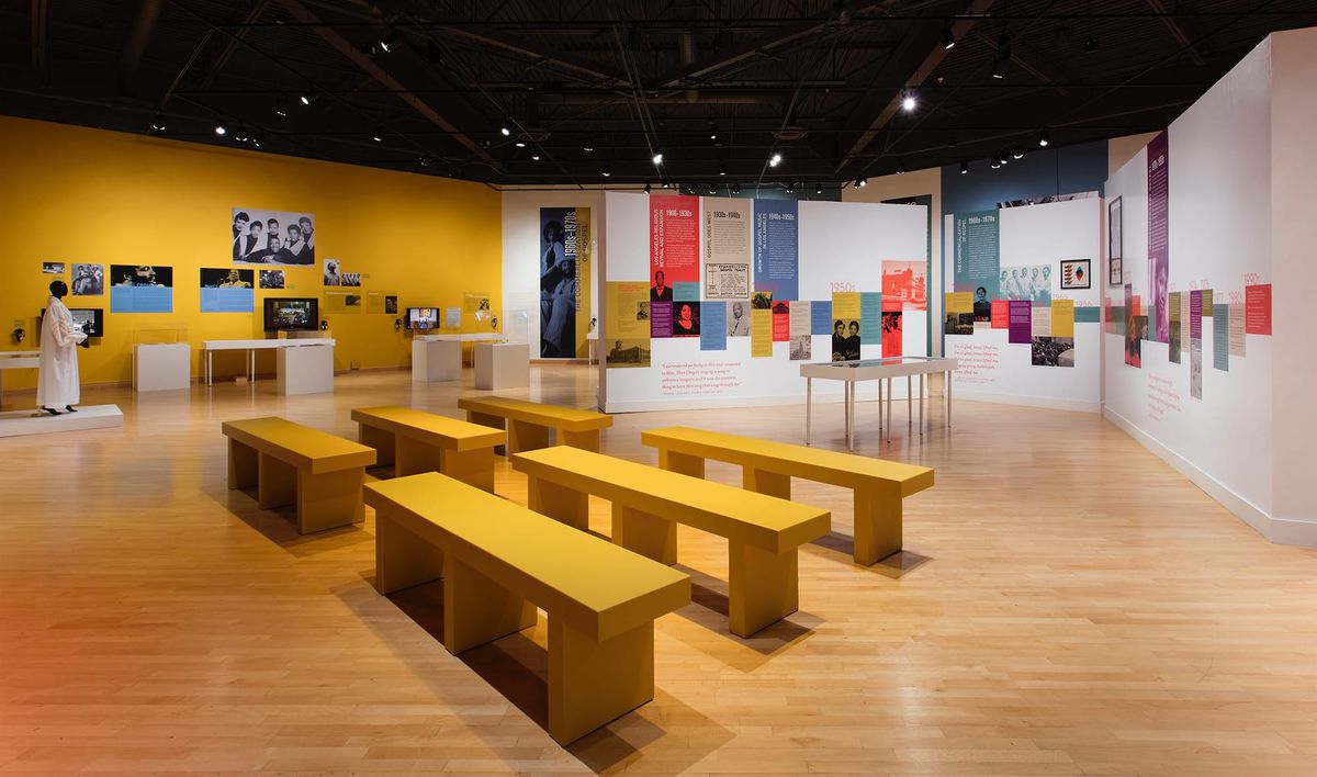 Installation view with benches arranged like church pews