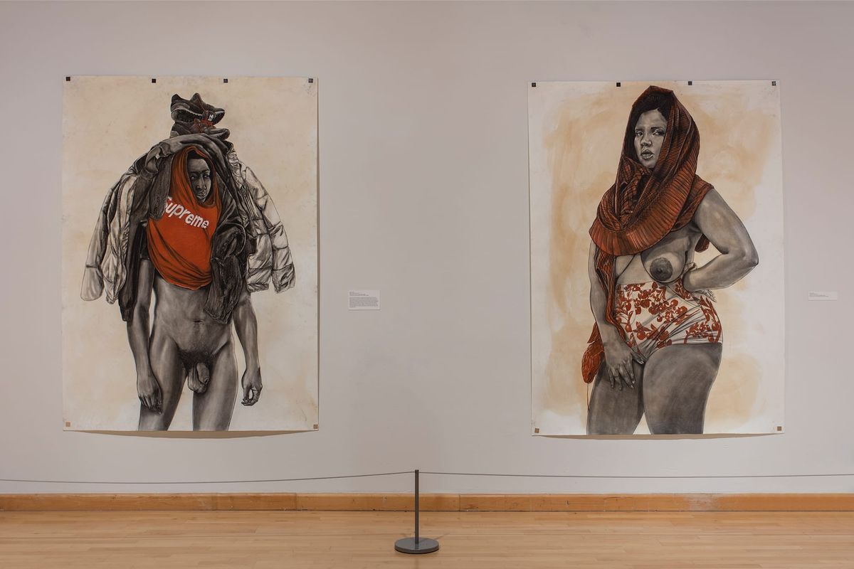 Installation view of two large scale paintings on paper of people in a mixed state of nude and with clothing draped on