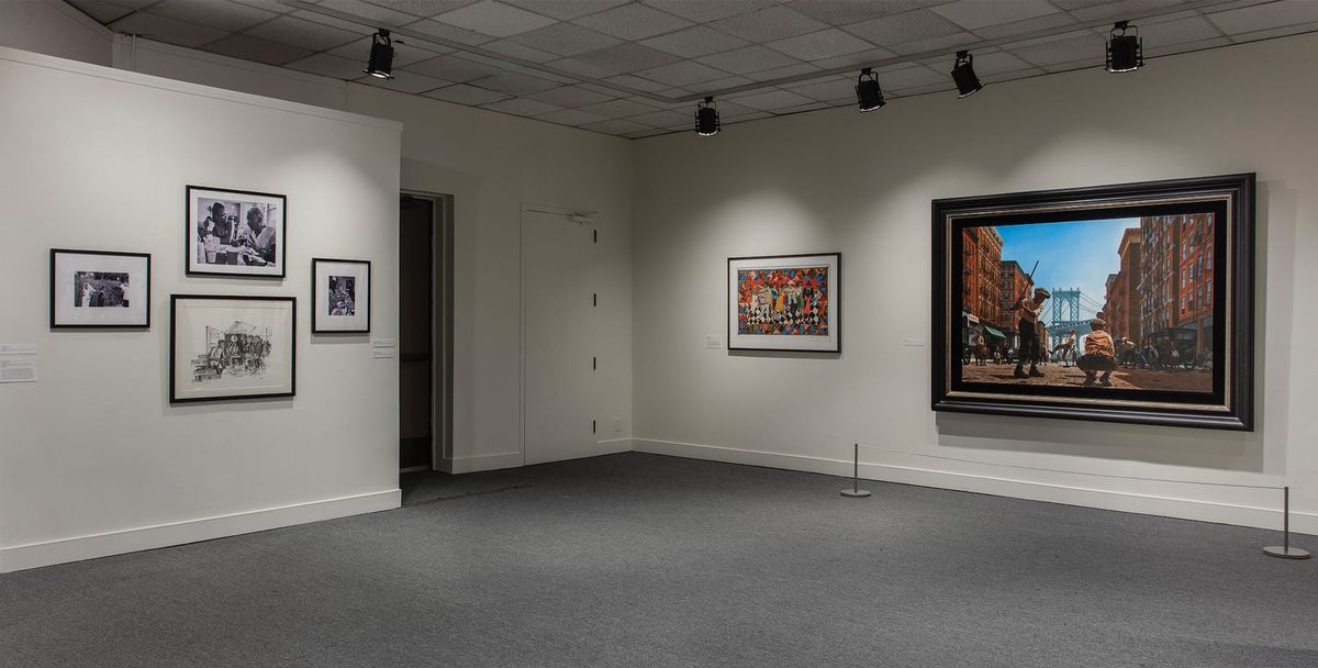 Installation view of framed photos and framed paintings