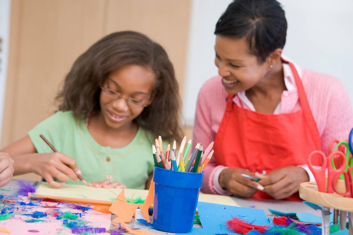 Student and teacher making crafts