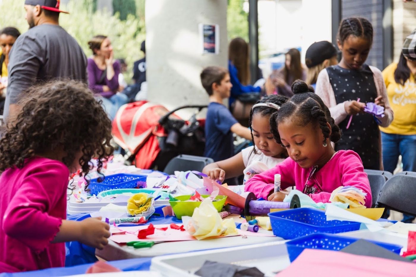 Children crafting at arts table during workshop