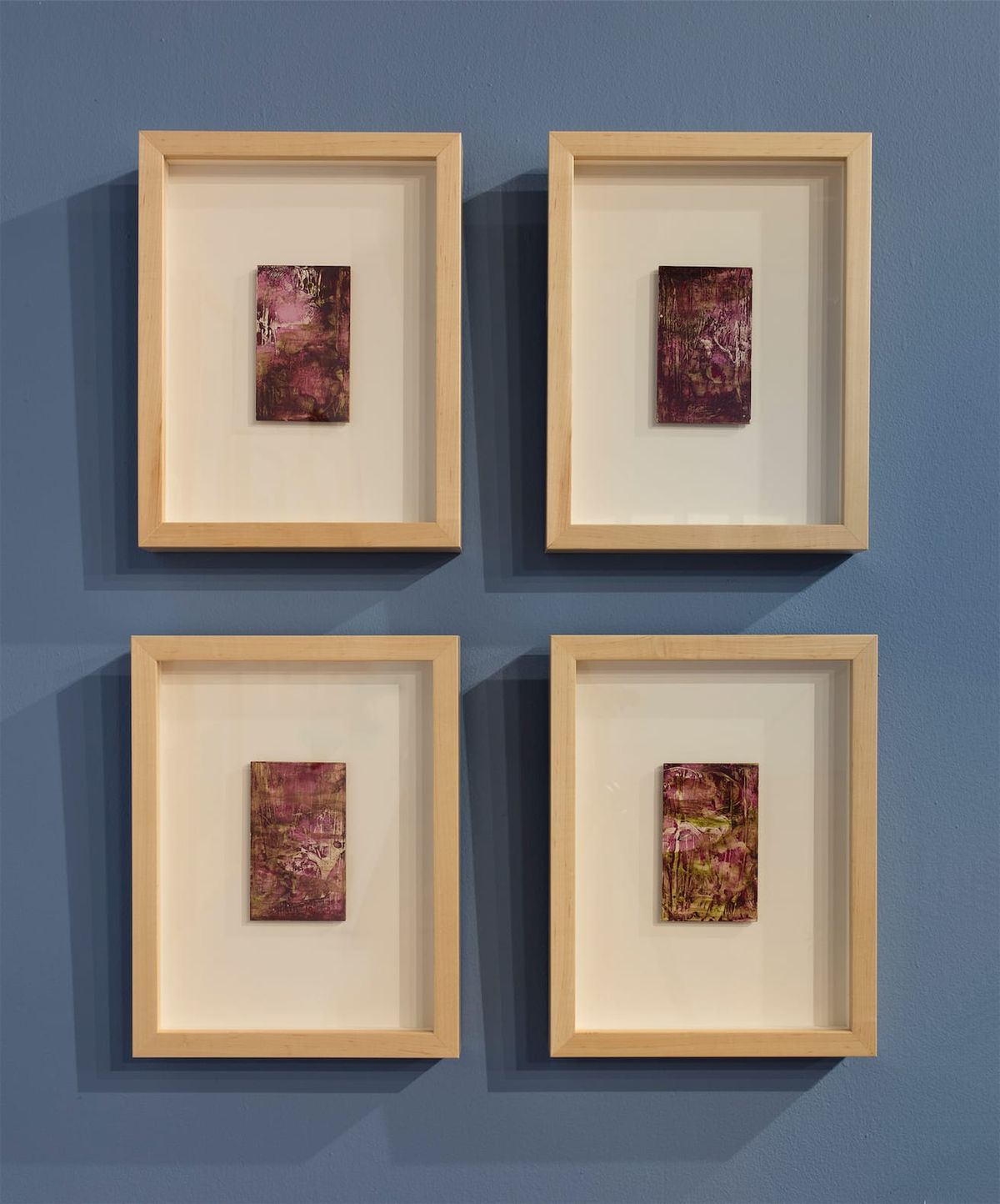 Exhibition view of four framed works
