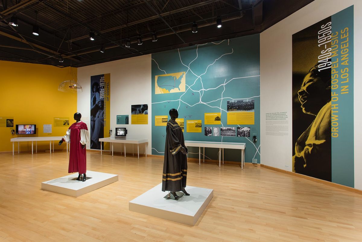 Installation view of gallery space with large scale images of gospel singers and supporting garments