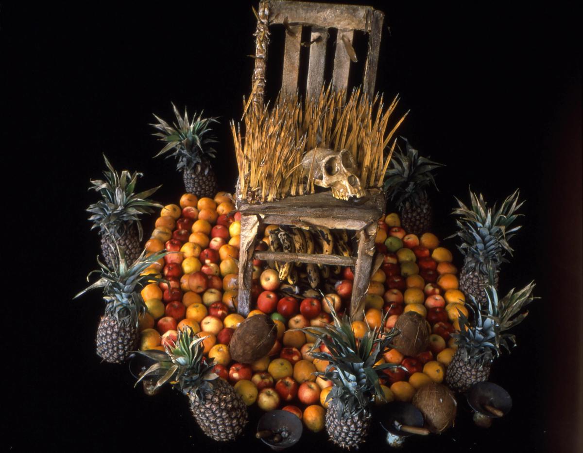 Throne with skull atop a platform of fresh fruit