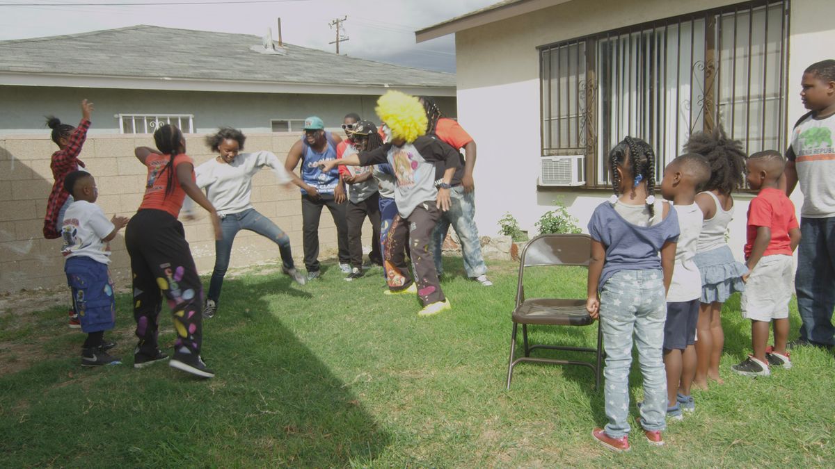 Children playing games led by clown