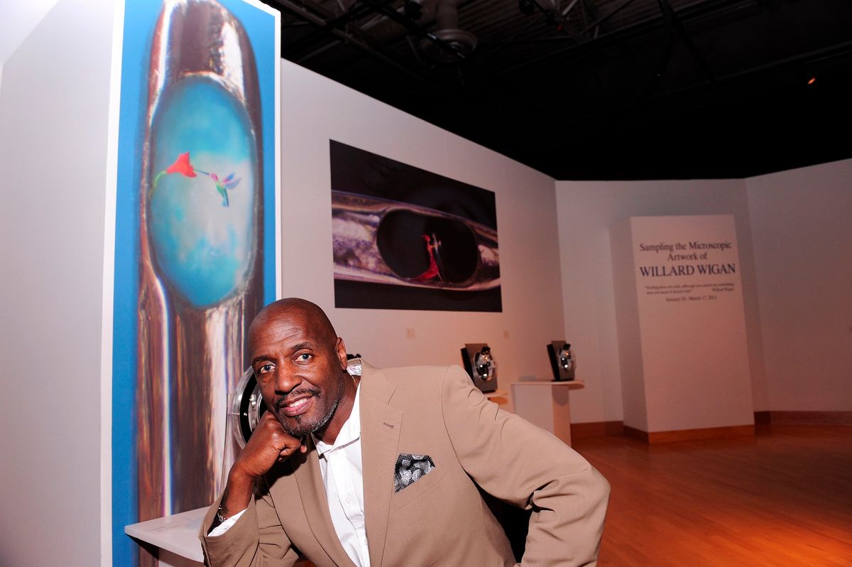 Portrait of Willard Wigan in an installation of his work