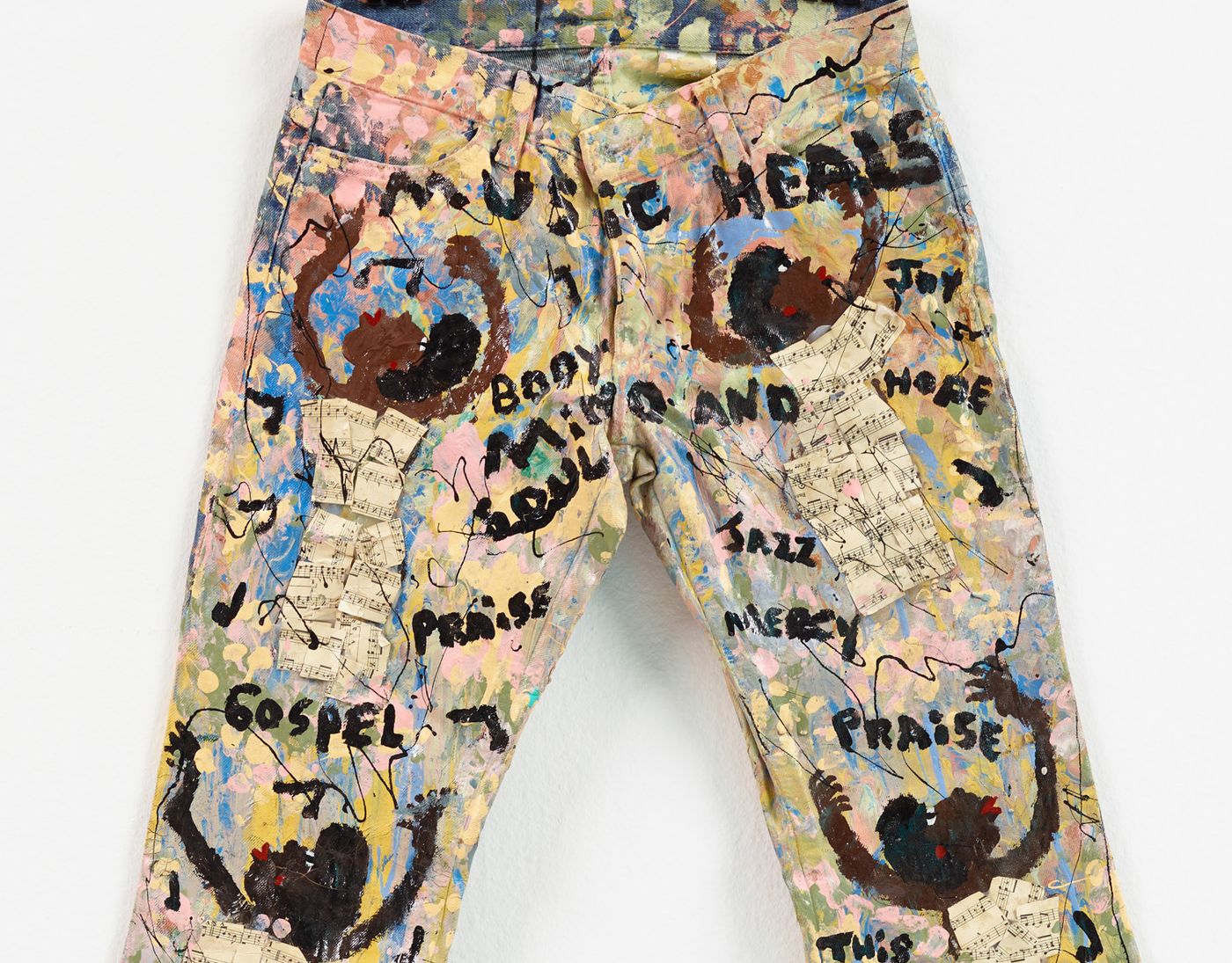 Pair of jeans painted with people and names of music genres