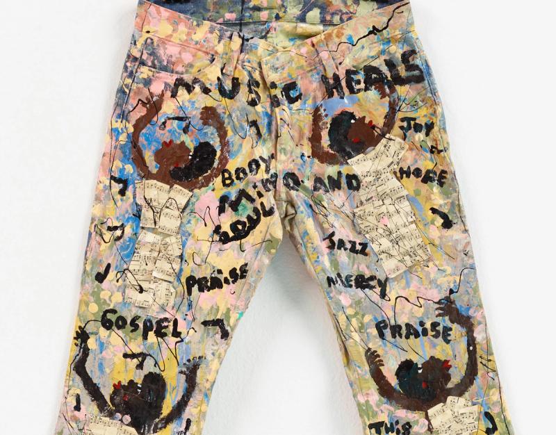 Pair of jeans painted with people and names of music genres
