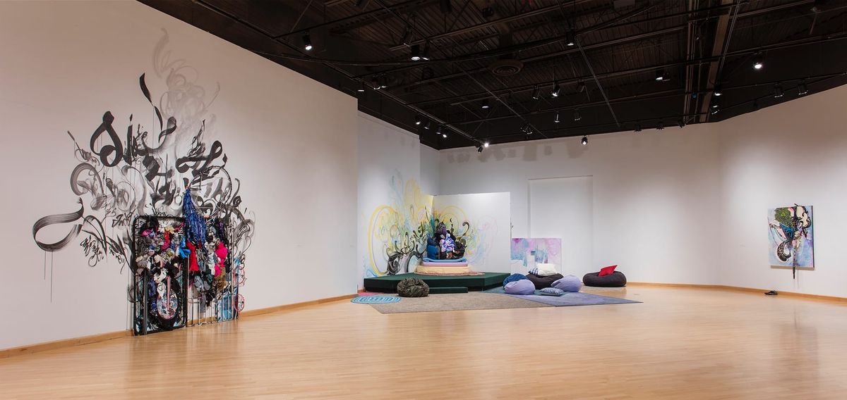 Installation view of soft furnishings space and mixed media painting