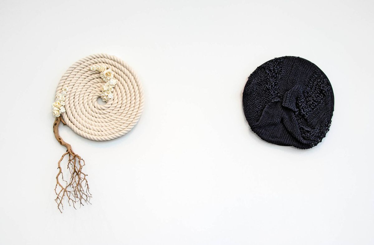 Two circles of large cord, one flat and white, one texturally variegated and black