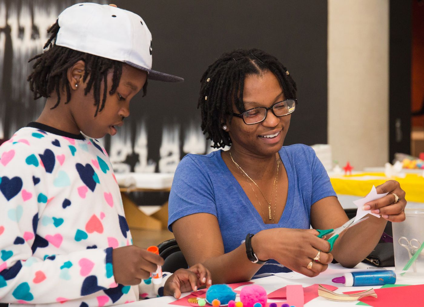 Family participating in an art workshop