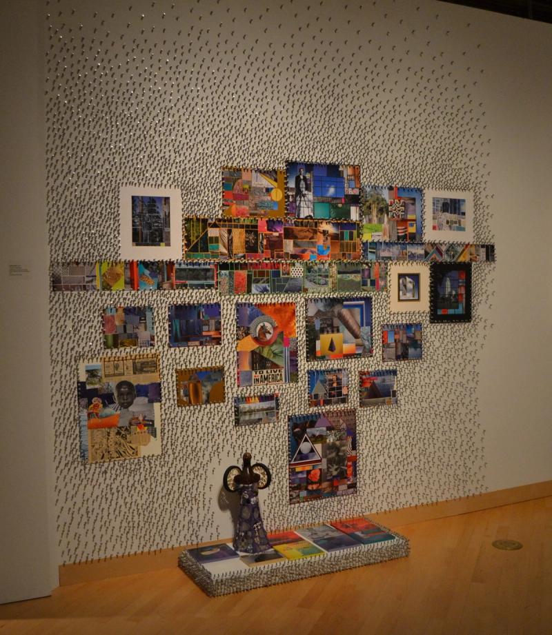 Installation of nails in wall as texture, collage of smaller framed works, and small statues