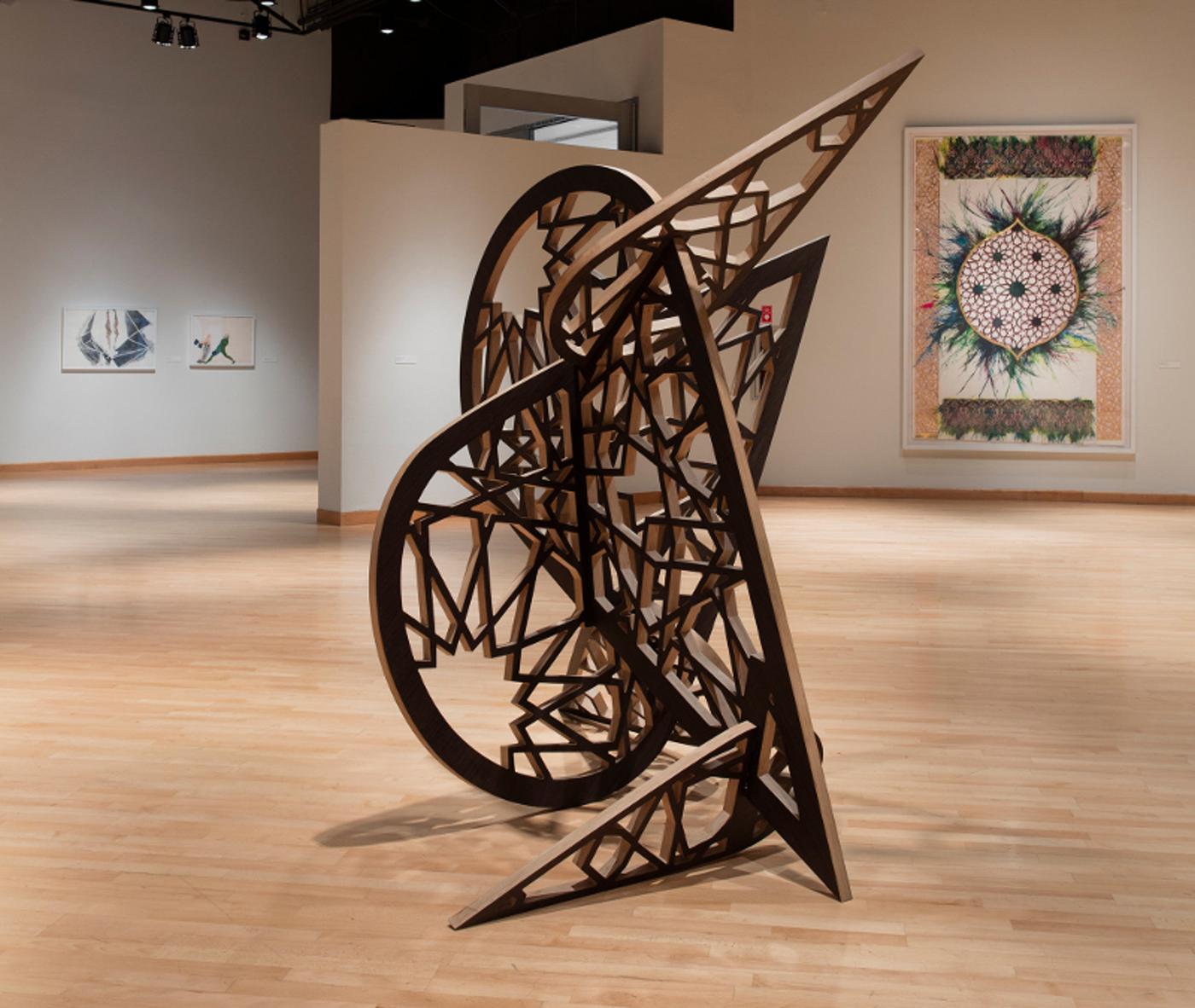 Installation view of grand-scale wood sculpture in Islamic geometric shapes