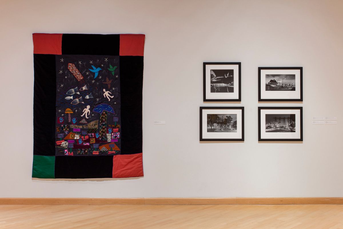 Installation view of story quilt and framed photographs