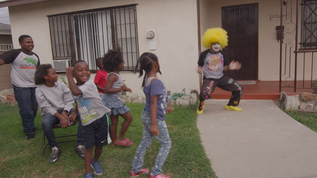 Family on greed lawn with clown