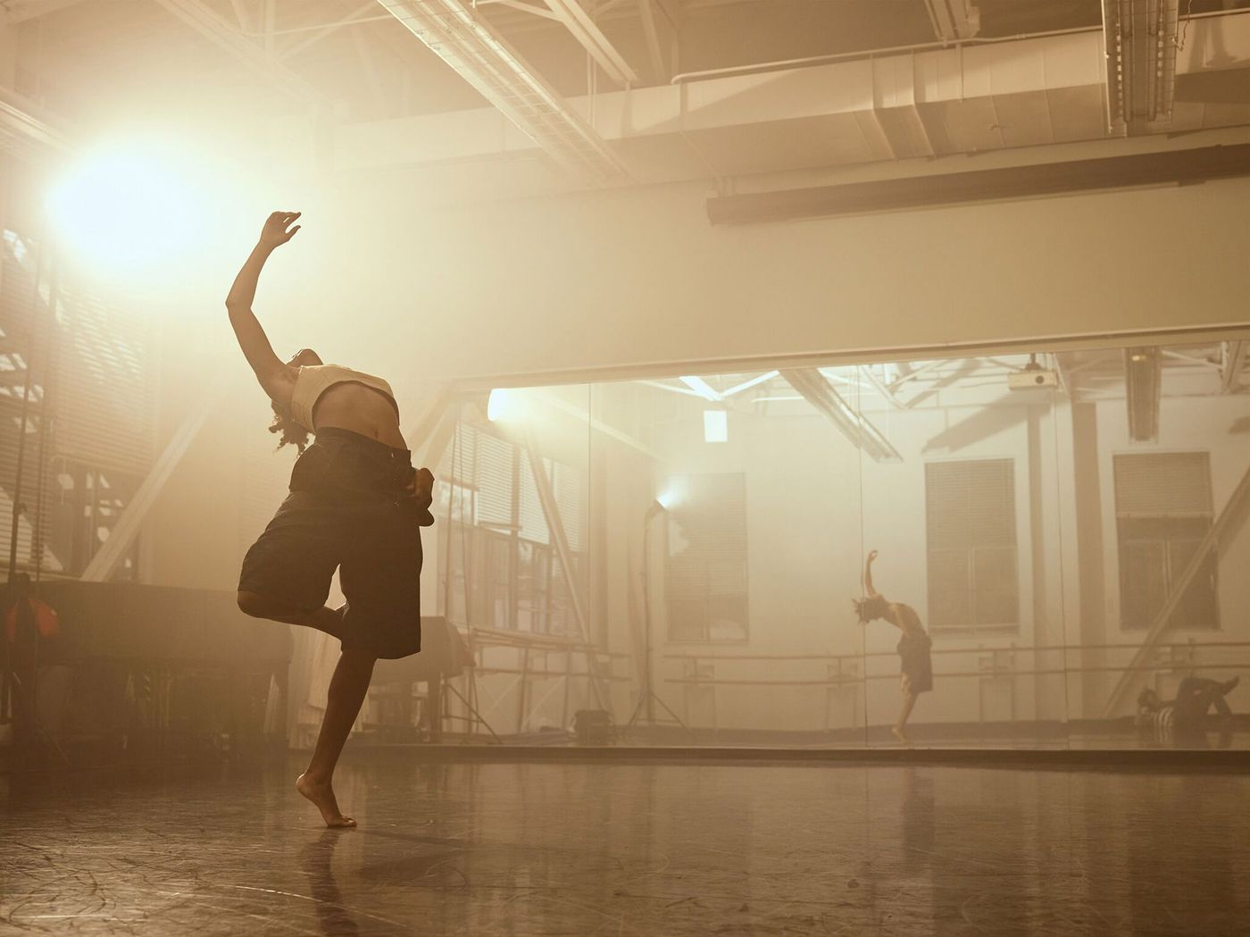 Dancer caught mid gesture inside dance studio