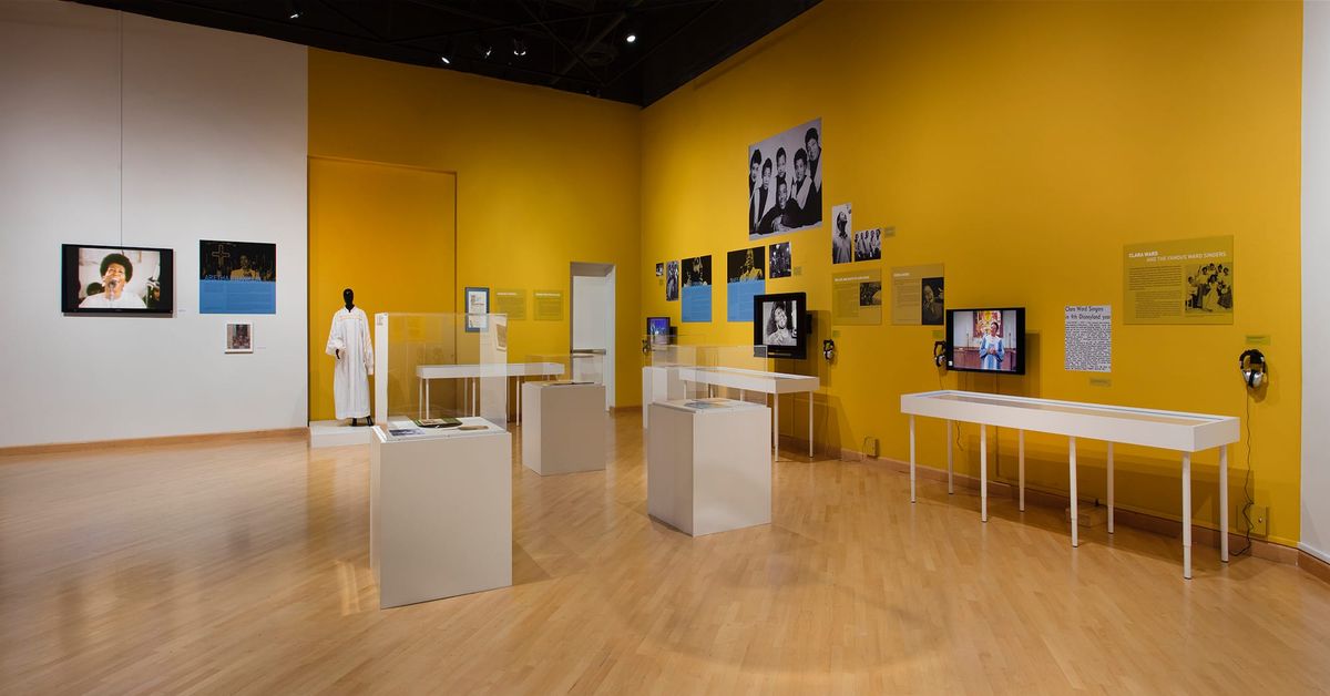 Installation view of monitor, photo elements, and vitrines