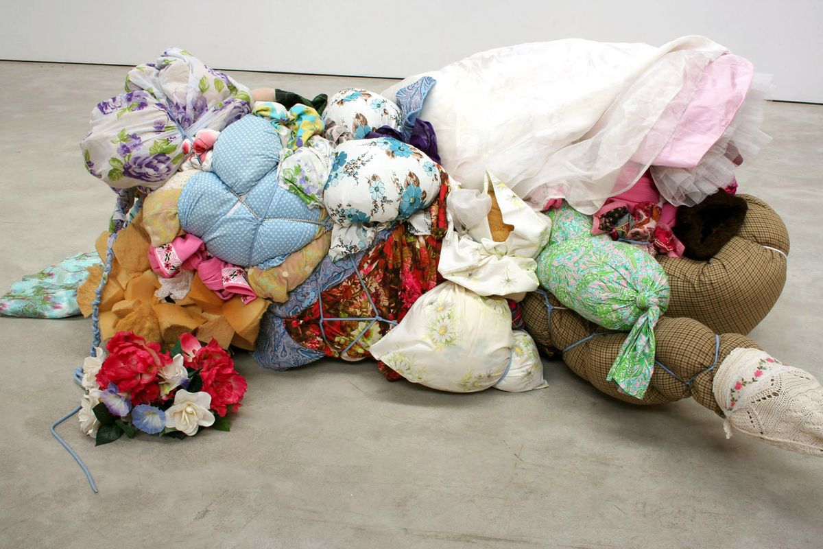 Soft sculpture of bundled, stuffed clothing