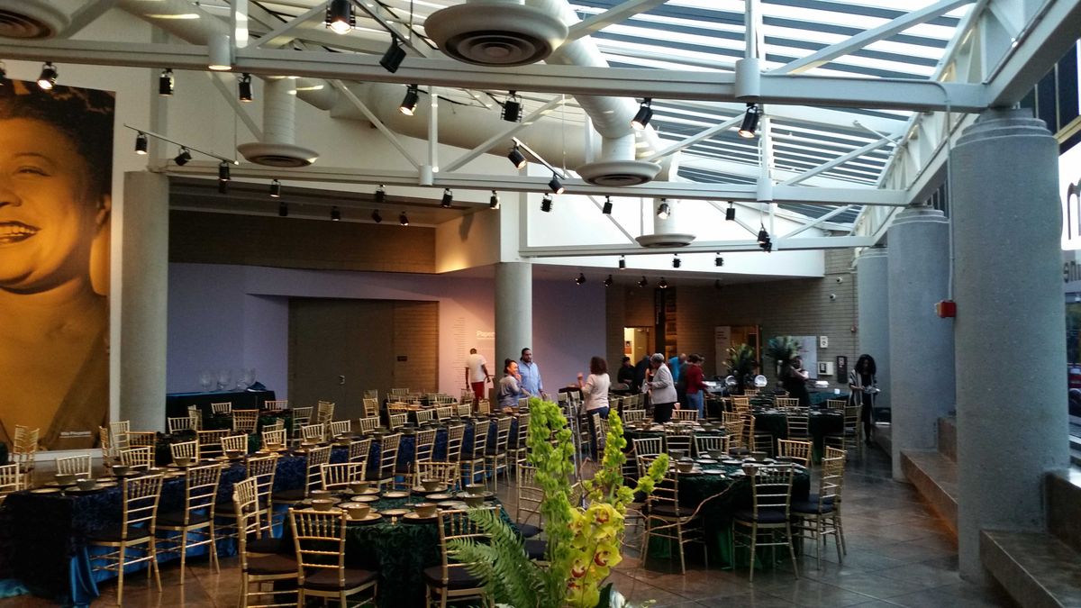 Atrium set up with elegant floral arrangements, dining tables, for formal event