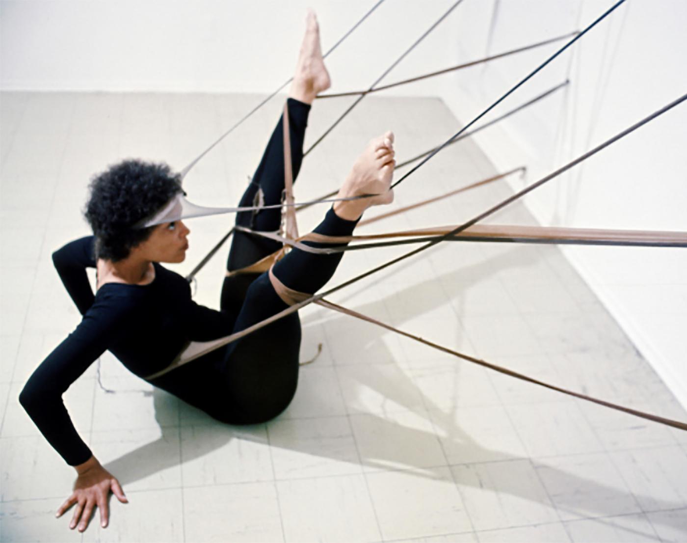 Performance installation of bands and rigging, activated by performer in black unitard