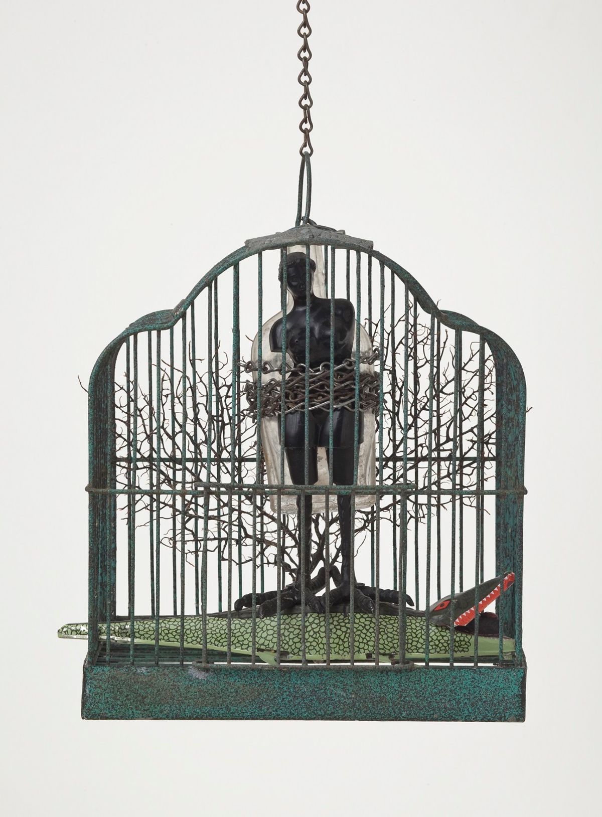 Ebony female form bound inside bird cage