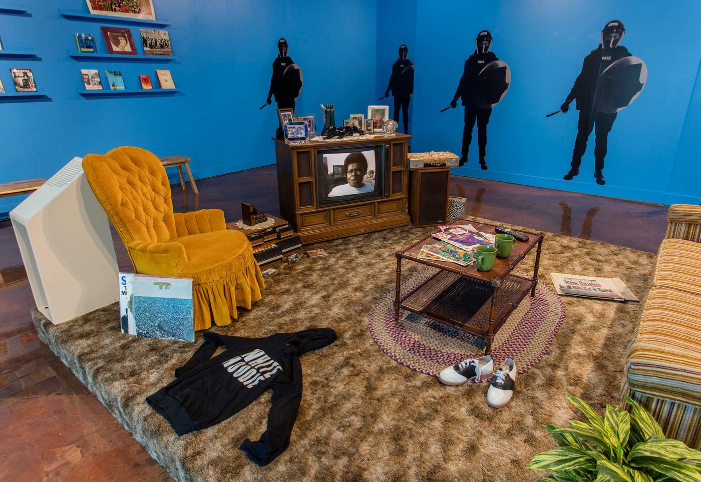 Installation of living room in 1970s decor and colorstory of blues, tans, and golds