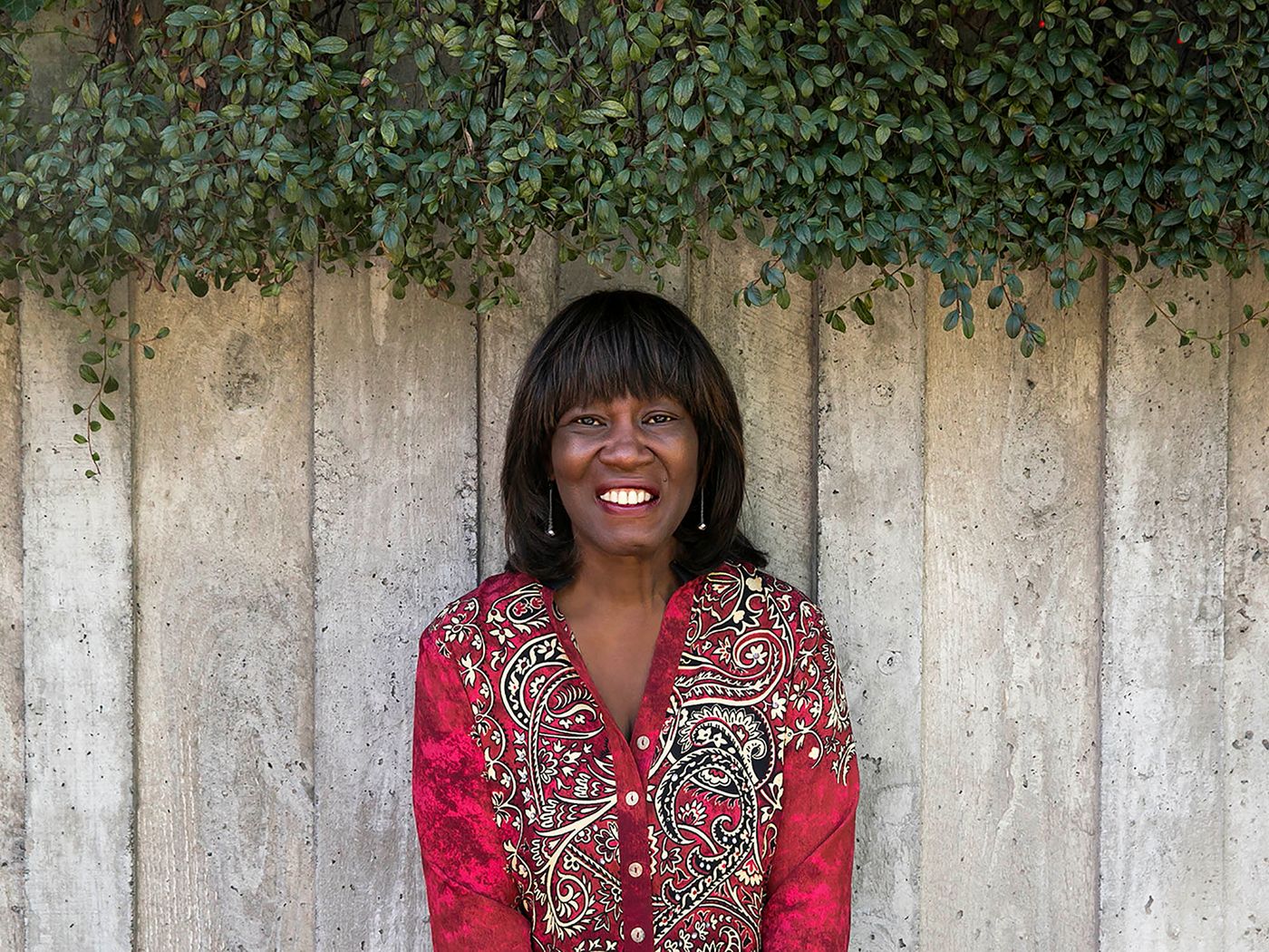 Patricia Smith surrounded by well-manicured greenery
