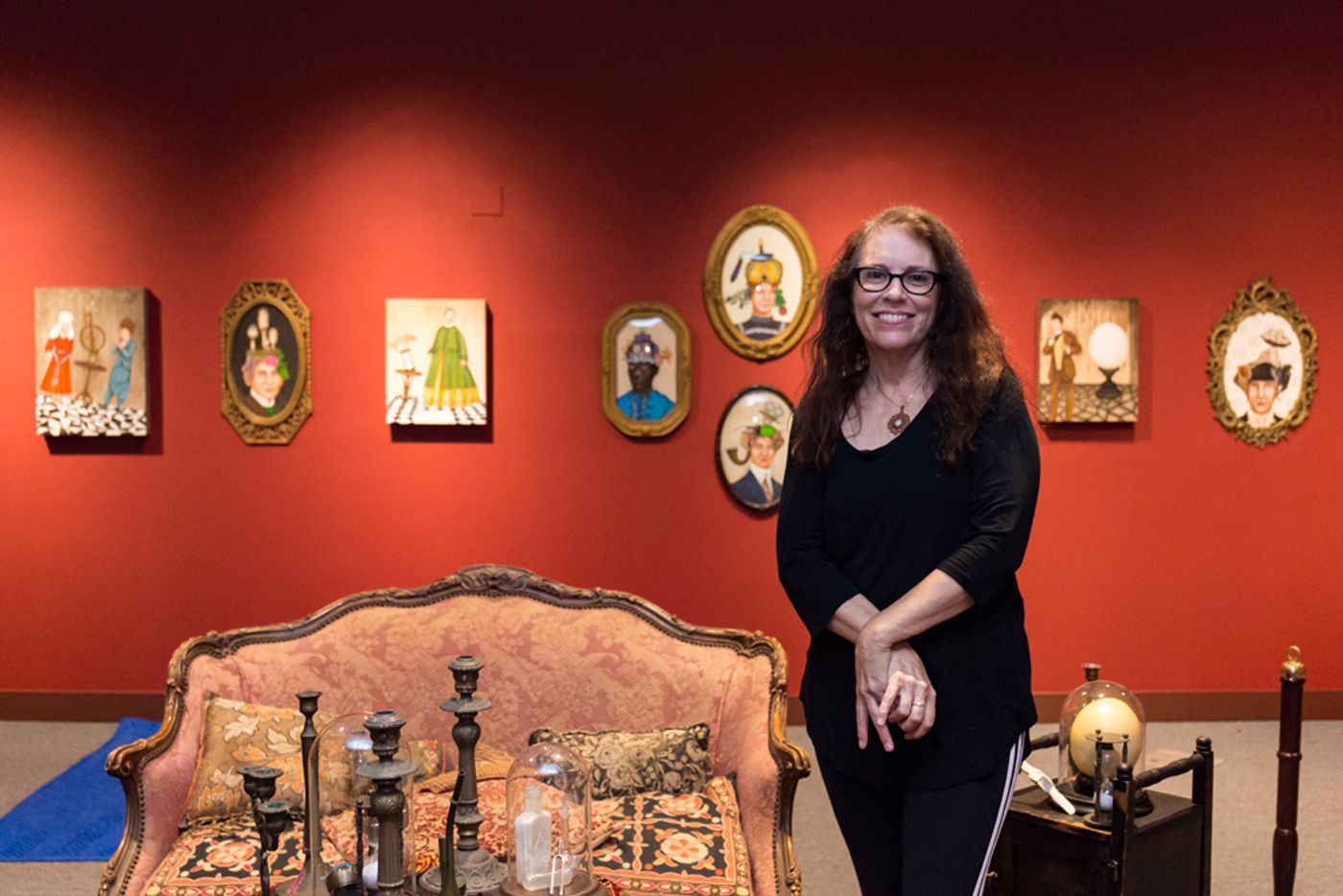 Portrait of Lezley Saar in front of her artwork