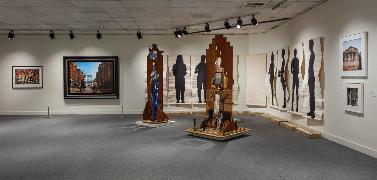 Installation view of sculptures and large-scale ink on paper works