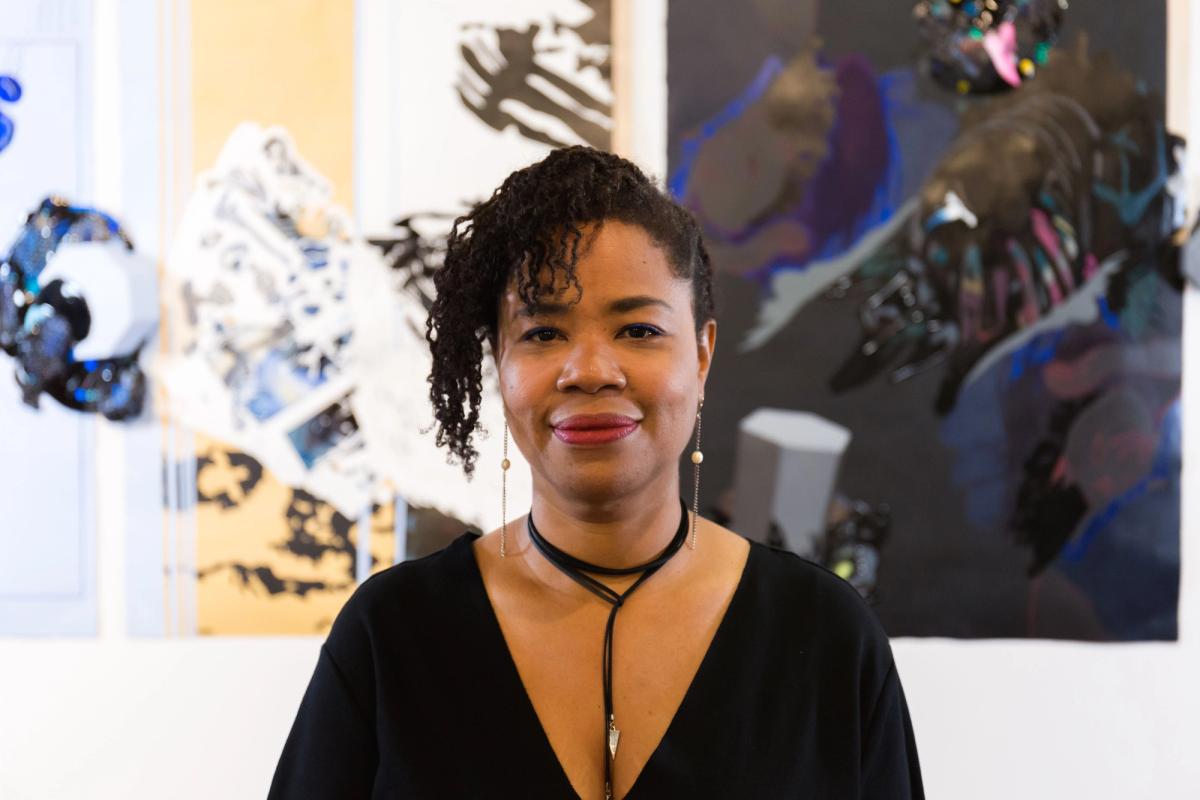 Portrait of Nicole Awai in front of her work