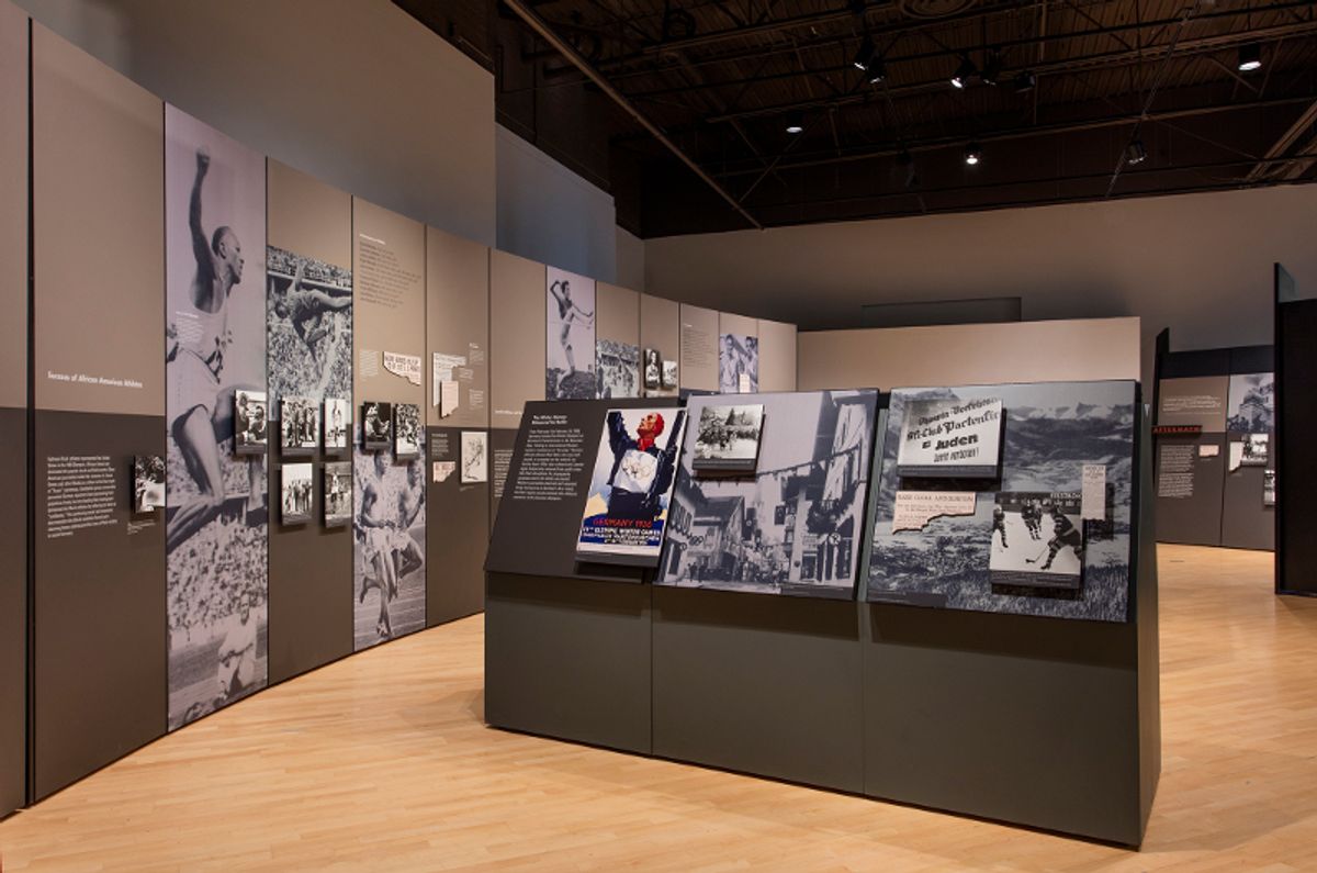 Installation view of wall text, posters from the time, and athelete photos