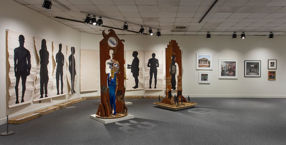 Installation view of sculptures and large-scale ink on paper works
