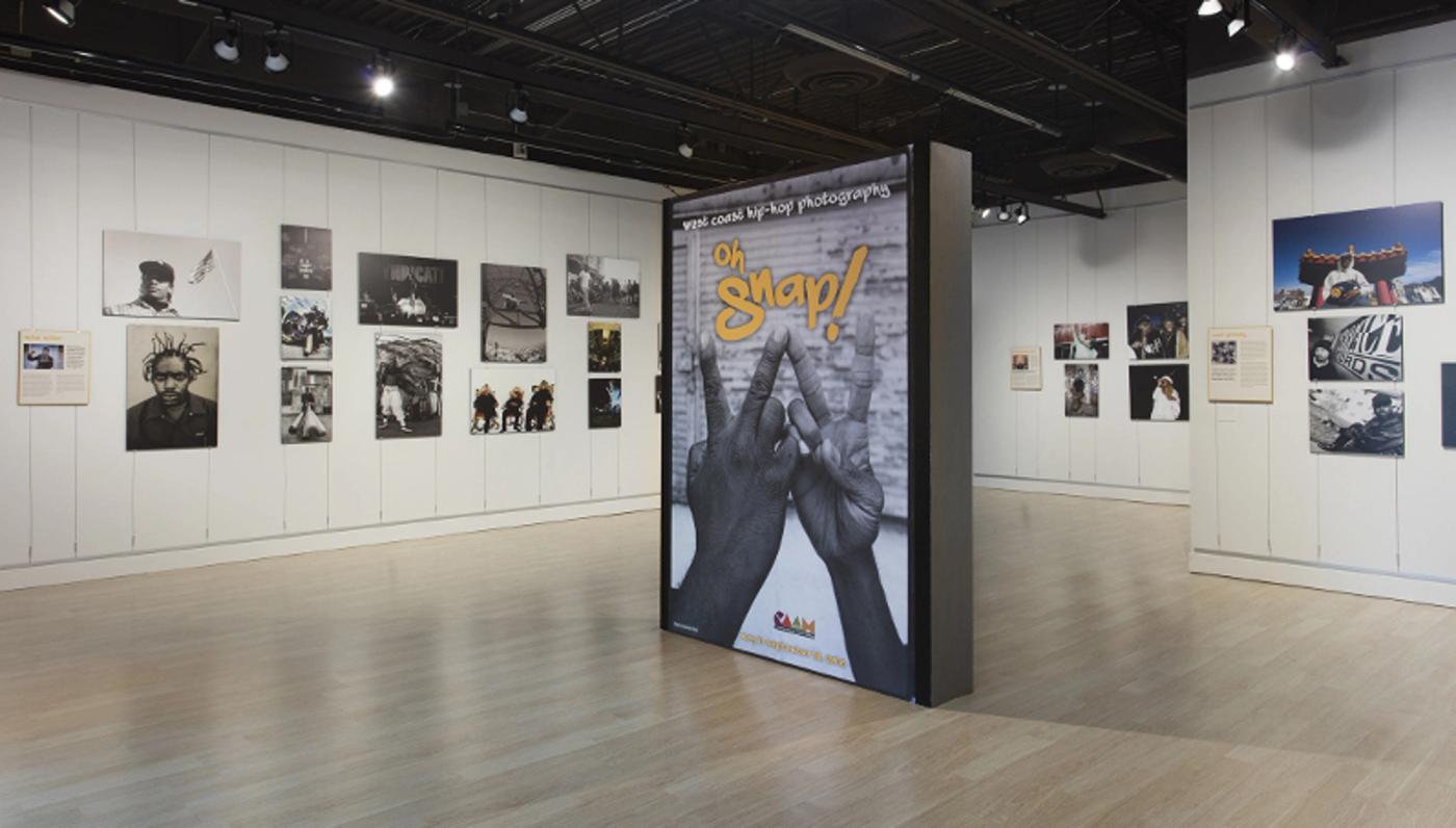 Installation view of many photographs of hip hop artists across it's four elements