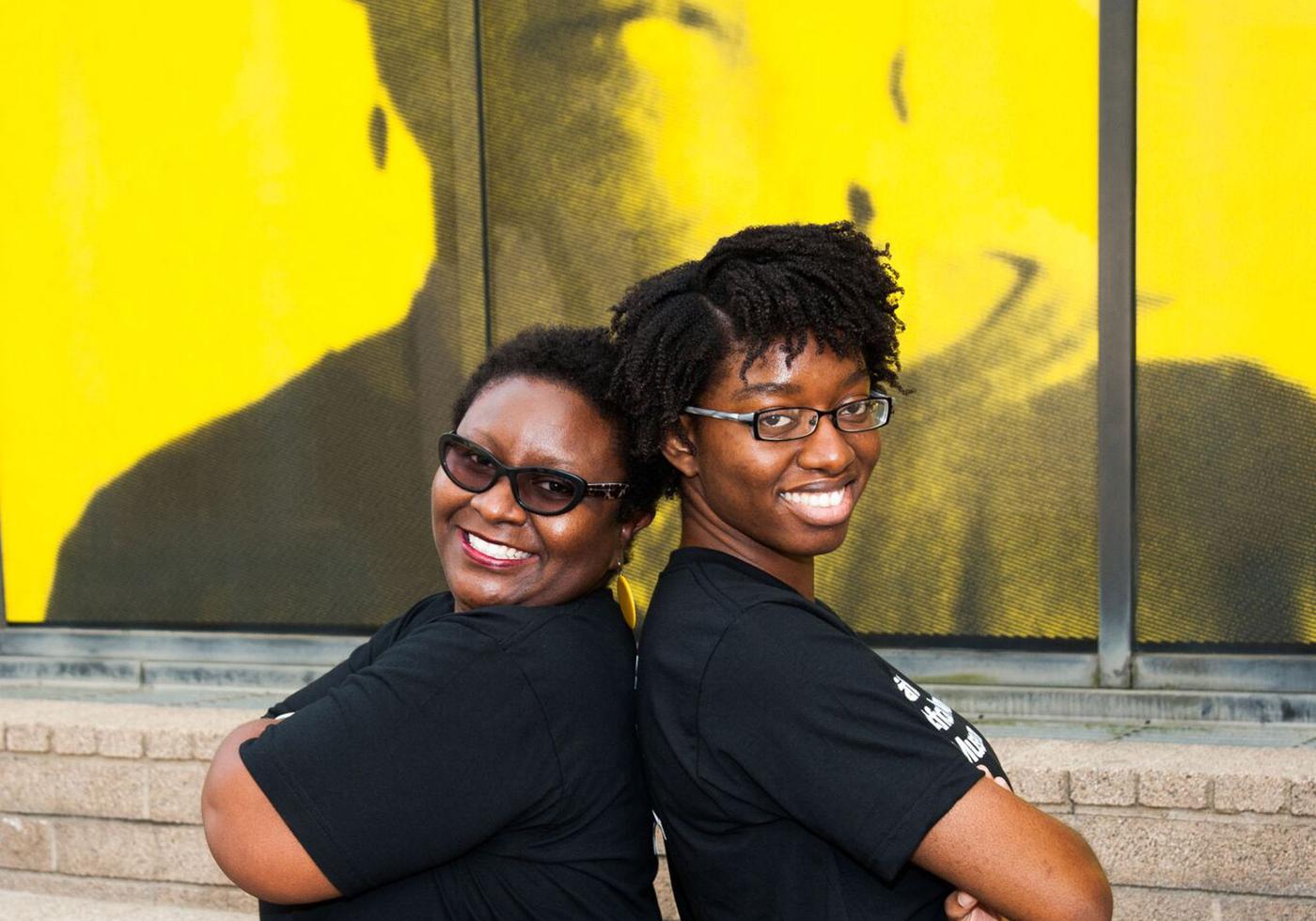 Museum staffers smiling toward viewer