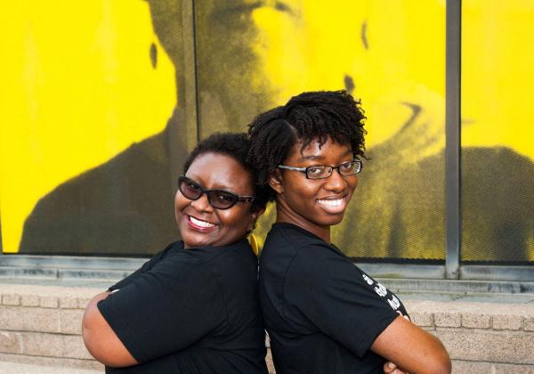 Museum staffers smiling toward viewer